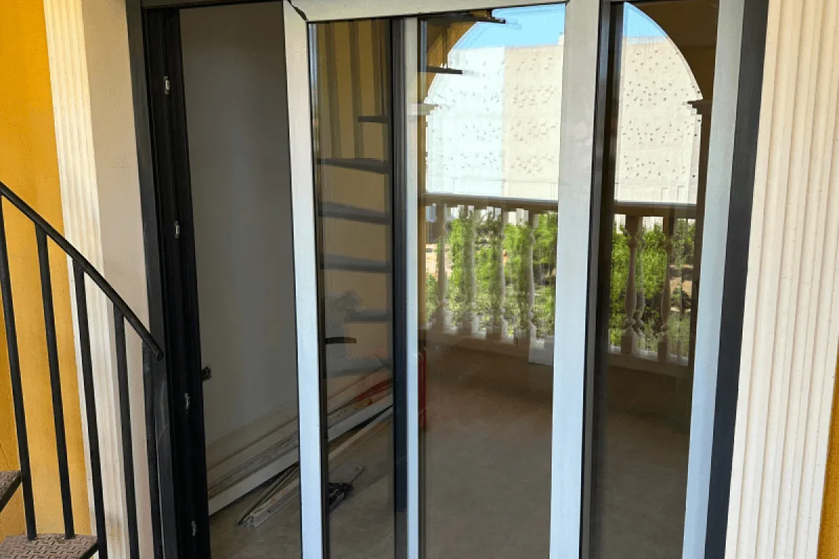 Sliding door with mosquito screen on a balcony